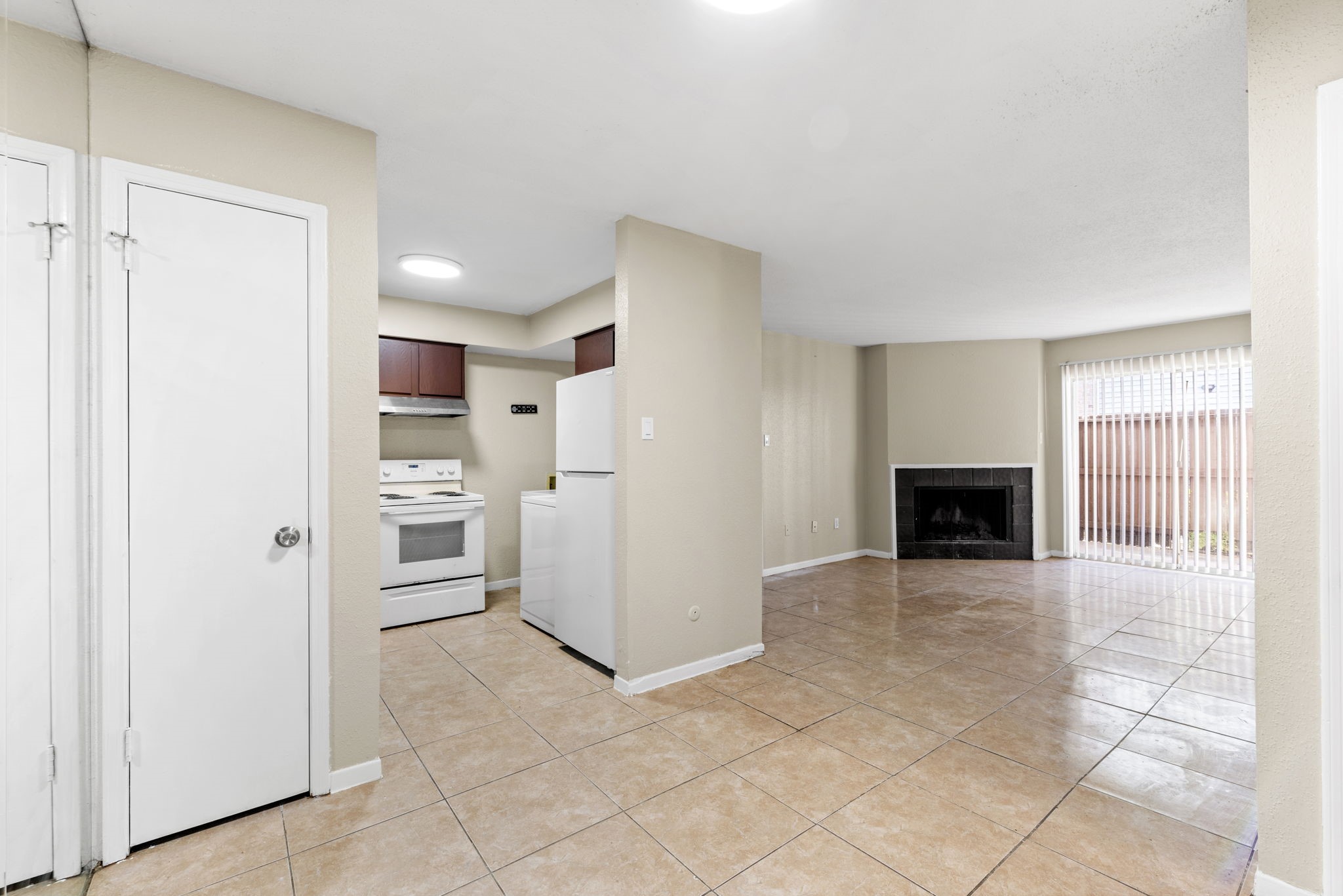 a view of a kitchen with refrigerator cabinets and an empty room