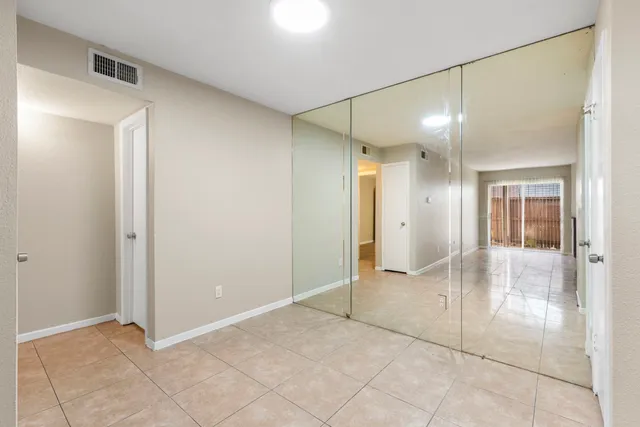 a view of a kitchen with a sink and a refrigerator