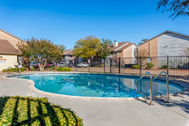 a view of swimming pool with outdoor seating and plants
