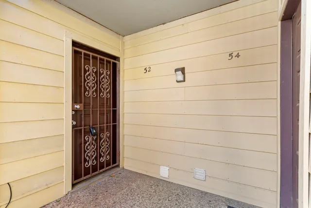 a view of an empty room with a fireplace and a window