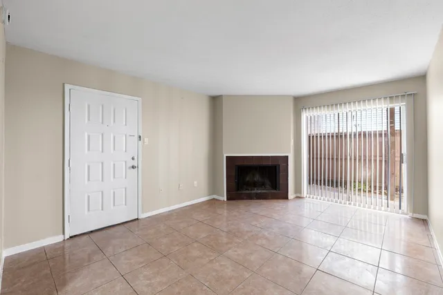 a view of an empty room with a fireplace