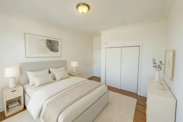 a bedroom with a bed and a lamp