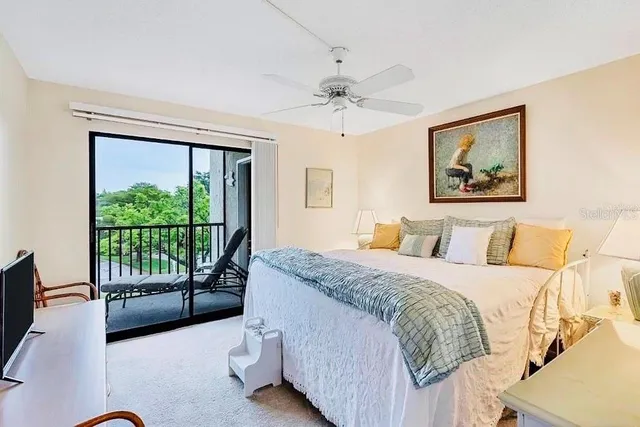 a spacious bedroom with a bed and a large window