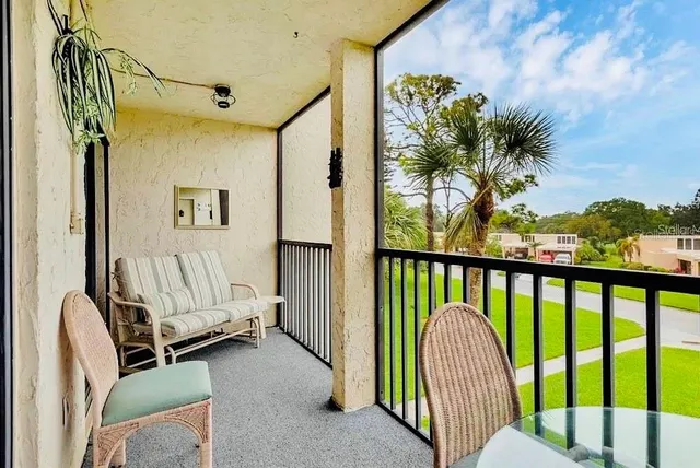 a view of a balcony with furniture