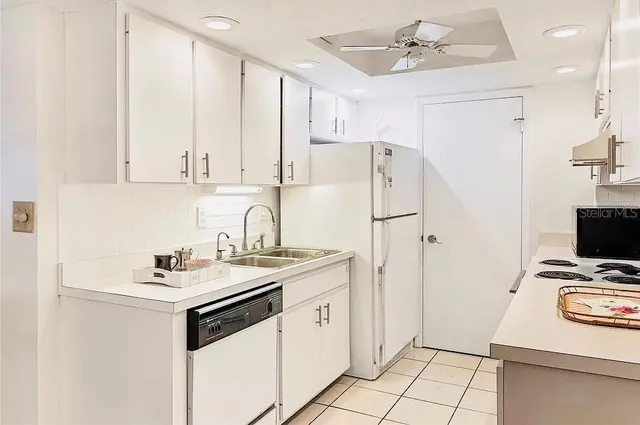 a kitchen with stainless steel appliances a refrigerator sink and cabinets