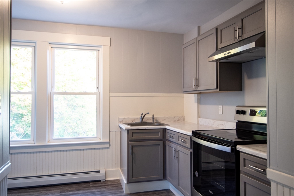 3 Bridge Street, Unit 2 Montague, MA 01349 - Photo 11 of 11 a kitchen with granite countertop a sink stainless steel appliances and cabinets