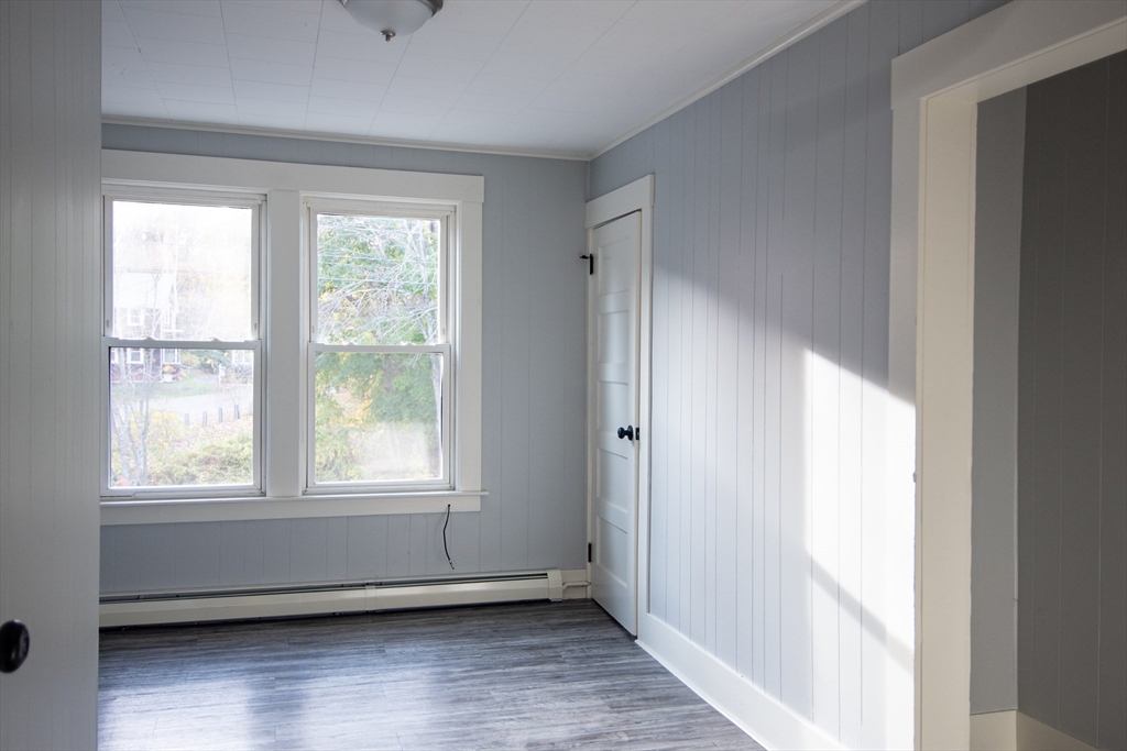 3 Bridge Street, Unit 2 Montague, MA 01349 - Photo 4 of 11 a view of an empty room with wooden floor and a window