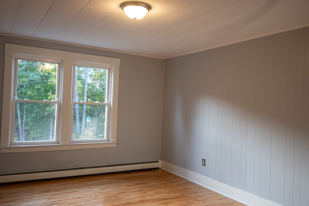 3 Bridge Street, Unit 2 Montague, MA 01349 - Photo 6 of 11 an empty room with wooden floor and windows