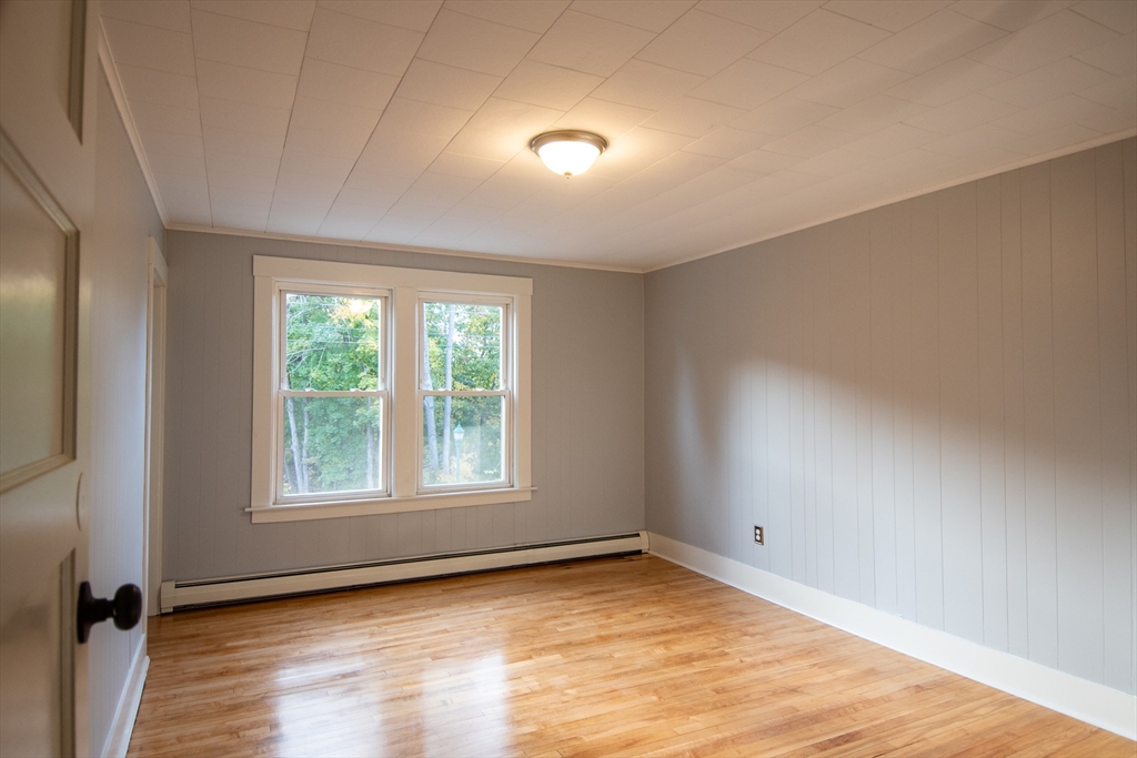 3 Bridge Street, Unit 2 Montague, MA 01349 - Photo 7 of 11 an empty room with wooden floor and windows