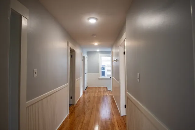 a view of hallway with wooden floor