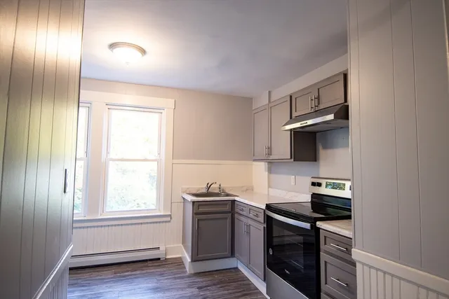 a kitchen with a sink and a stove top oven