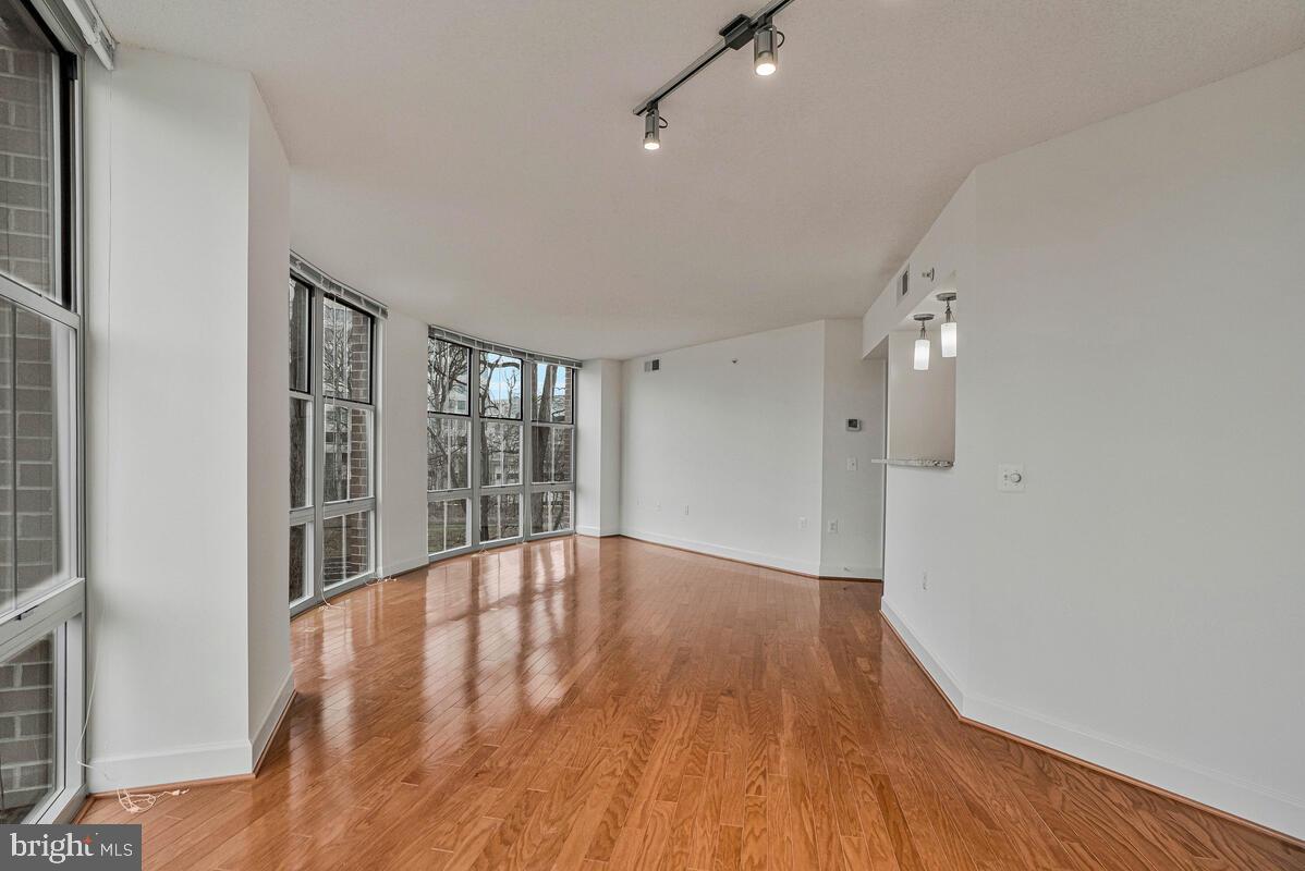 11800 Sunset Hills Road, Unit 514 Reston, VA 20190 - Photo 31 of 57 a view of an empty room with wooden floor and a window