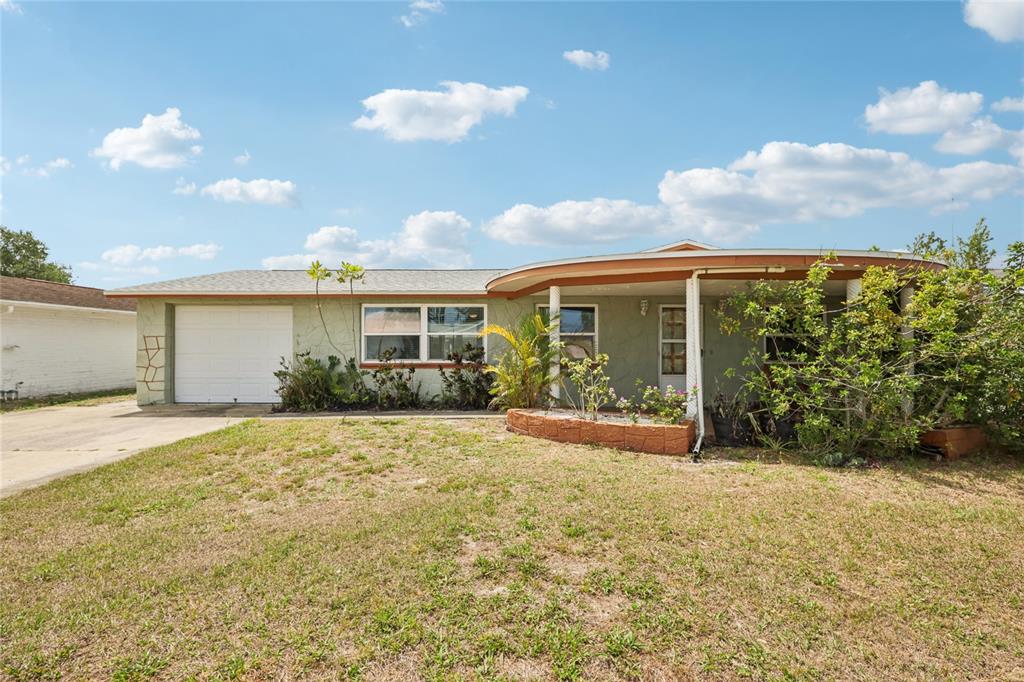 3548 Darlington Road Holiday, FL 34691 - Photo 1 of 32 a view of yellow house with a big yard and potted plants