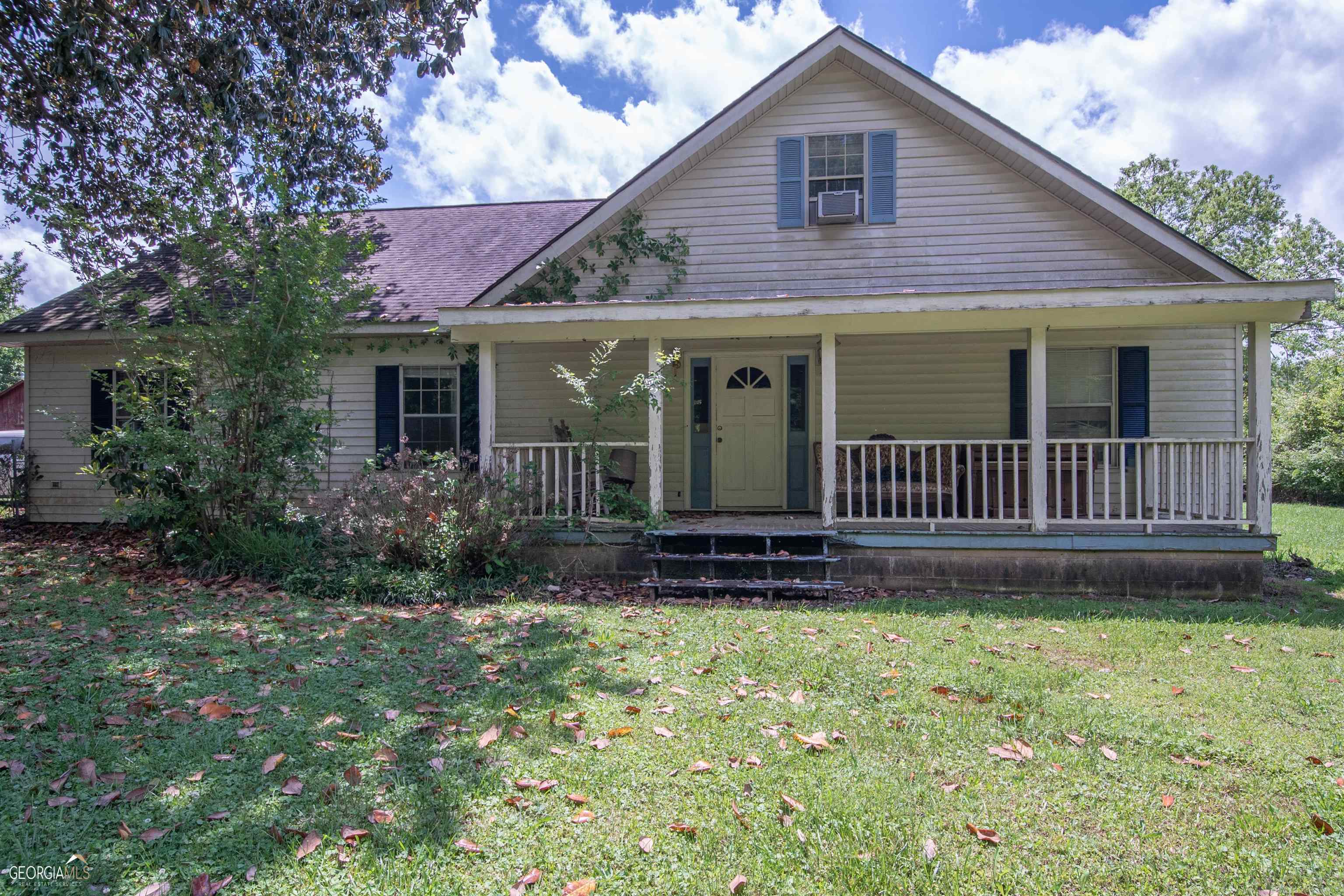5292 Newnan Road Griffin, GA 30223 - Photo 1 of 1 a view of a house with a yard and garden