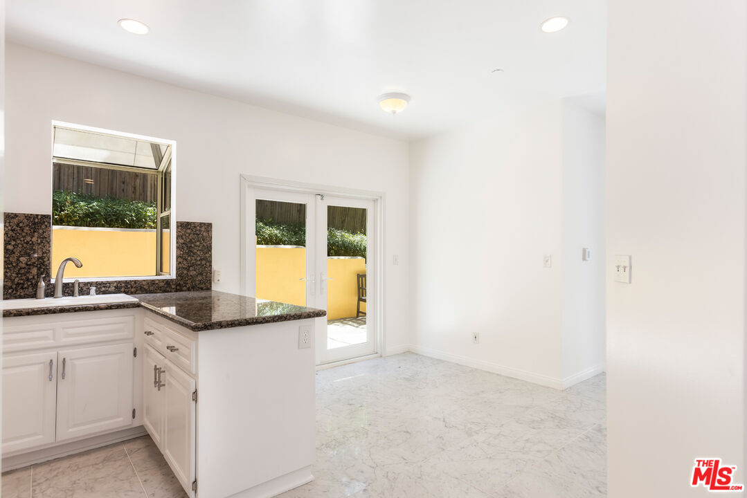 23636 Aster Trail Calabasas, CA 91302 - Photo 20 of 67 a kitchen with granite countertop cabinets and window