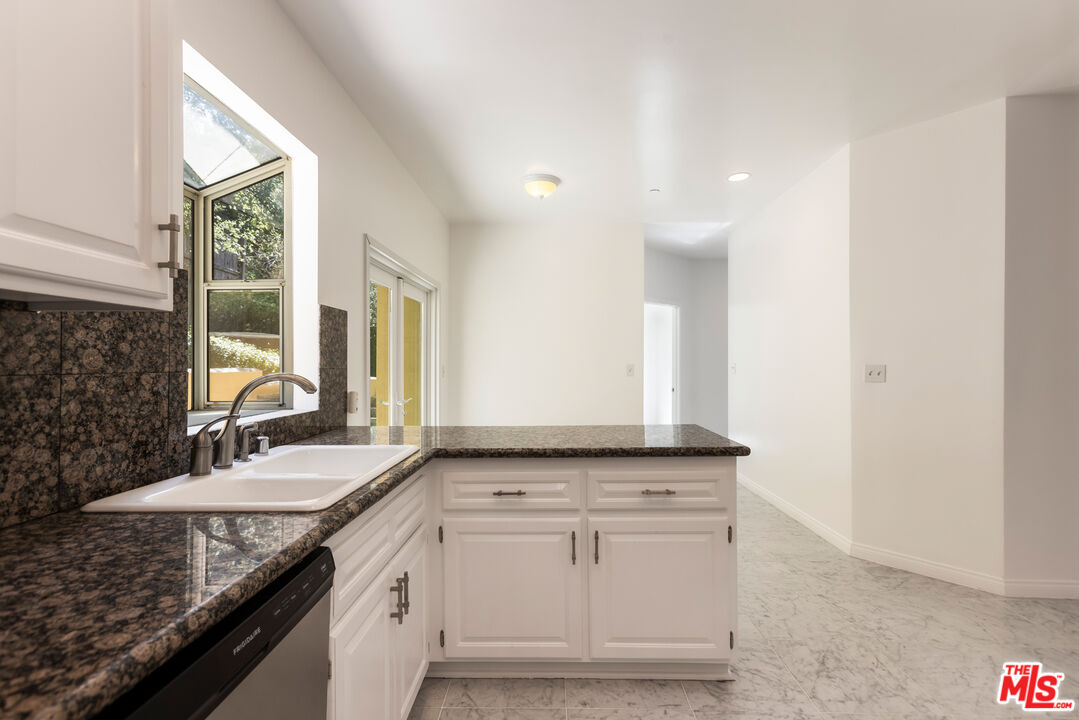 23636 Aster Trail Calabasas, CA 91302 - Photo 22 of 67 a bathroom with a granite countertop sink and a mirror
