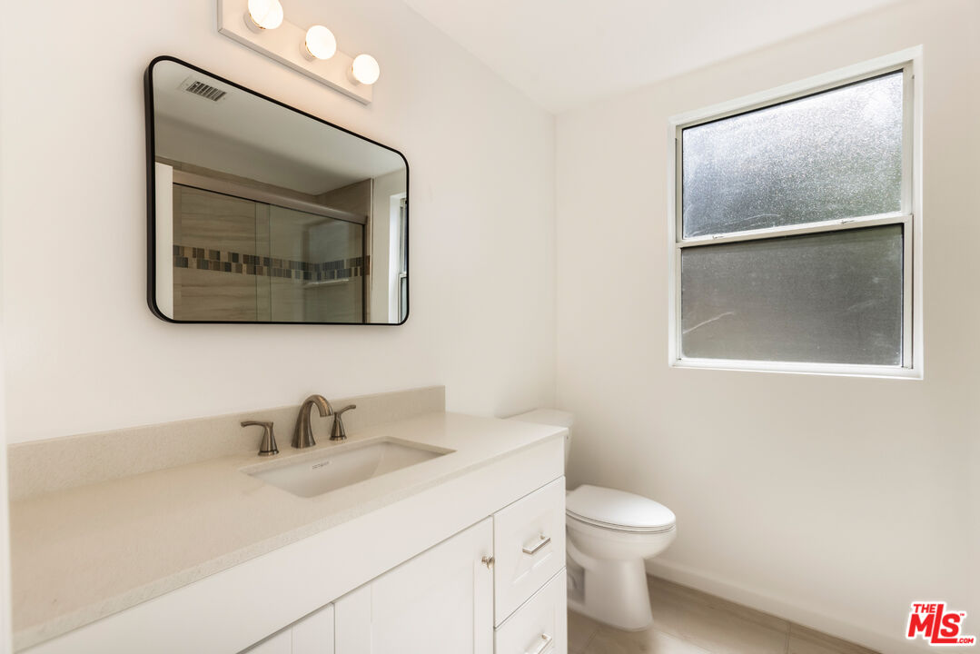 23636 Aster Trail Calabasas, CA 91302 - Photo 40 of 67 a bathroom with a toilet sink and mirror