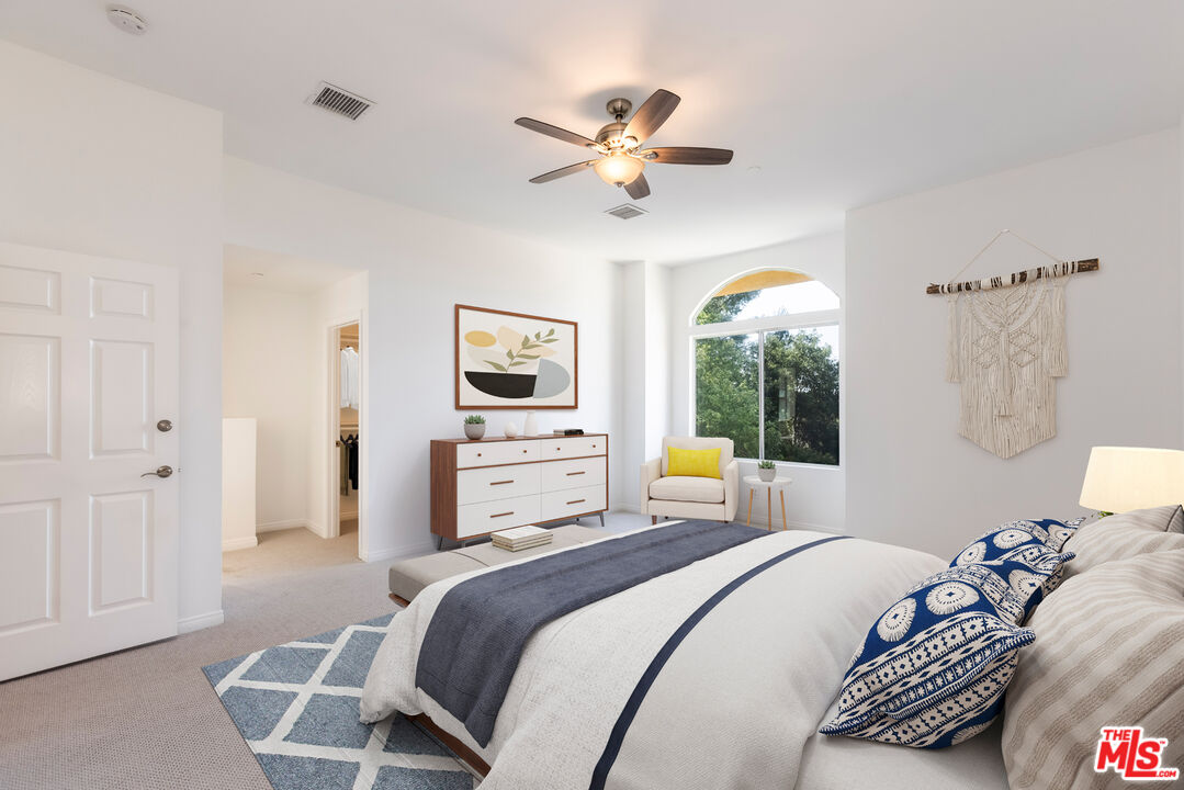 23636 Aster Trail Calabasas, CA 91302 - Photo 44 of 67 a bedroom with a bed and a chandelier