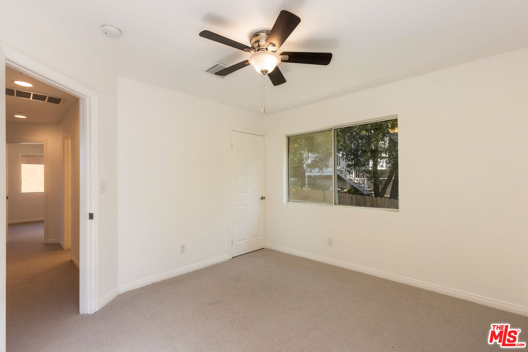 23636 Aster Trail Calabasas, CA 91302 - Photo 56 of 67 an empty room with a ceiling fan and a window