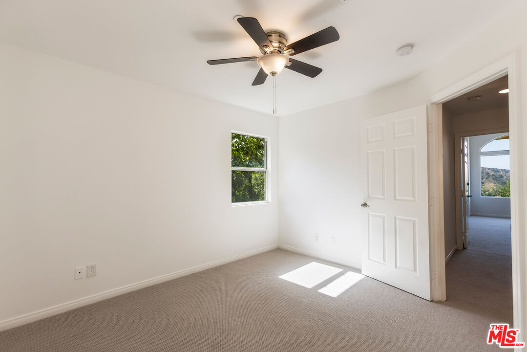 23636 Aster Trail Calabasas, CA 91302 - Photo 57 of 67 an empty room with a window and a fan