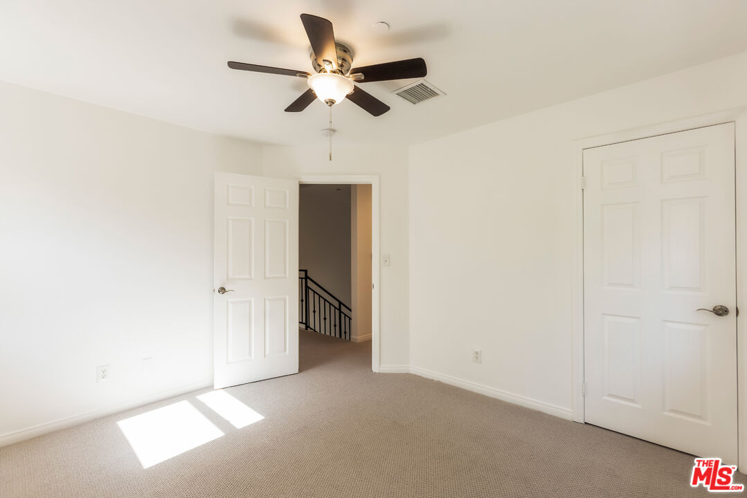 23636 Aster Trail Calabasas, CA 91302 - Photo 58 of 67 an empty room with a ceiling fan and a ceiling fan