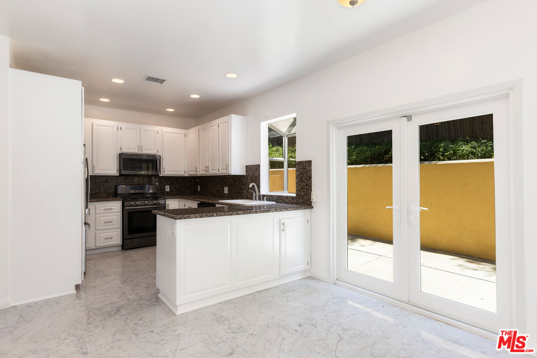 23636 Aster Trail Calabasas, CA 91302 - Photo 10 of 67 a kitchen with stainless steel appliances granite countertop a stove a sink and a refrigerator