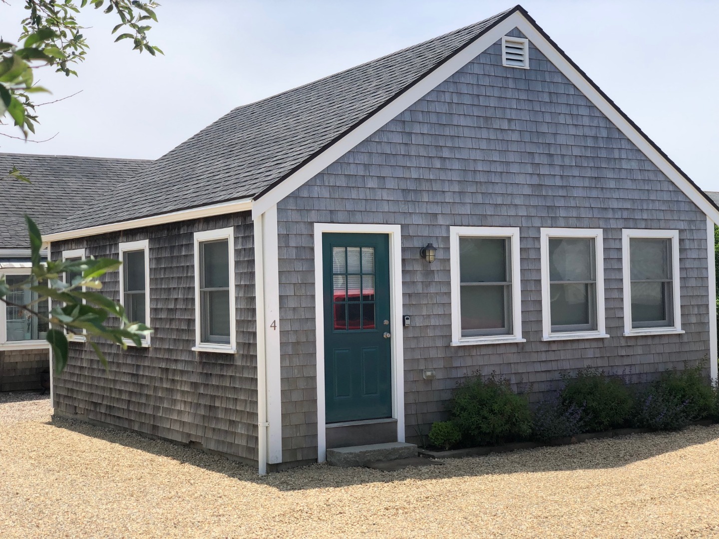 3 A Sun Island Road, Unit 4 Nantucket, MA 02554 - Photo 1 of 17 a front view of a house with garden