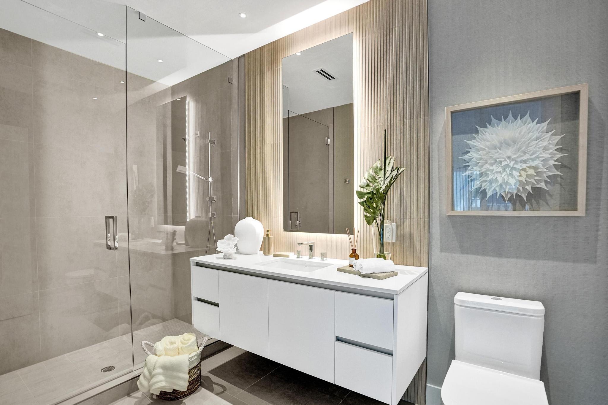 407 North Riverside Drive, Unit 203 Pompano Beach, FL 33062 - Photo 25 of 69 a bathroom with a toilet sink and shower