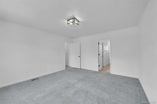 a spacious bathroom with a double vanity sink and mirror