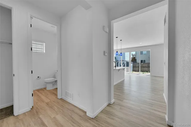 a kitchen with stainless steel appliances kitchen island granite countertop a sink a stove and a wooden floors