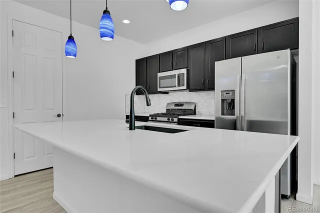 a kitchen with a sink and refrigerator