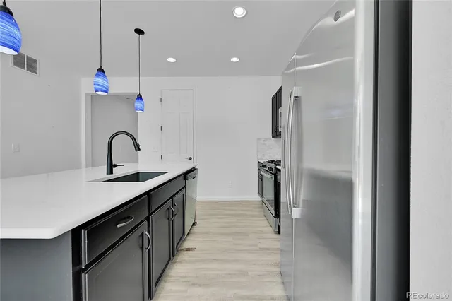 a kitchen with a sink a microwave and cabinets
