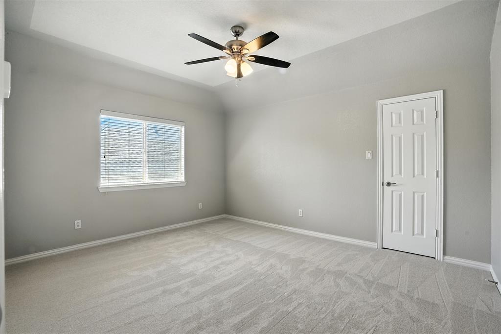 8220 Holliday Road Lantana, TX 76226 - Photo 35 of 40 Spacious room featuring light gray carpet, neutral wall paint, and a tray ceiling