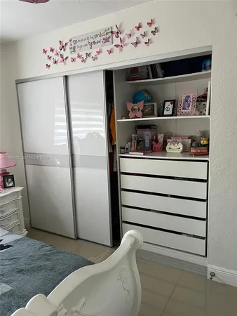 a living room with furniture a rug and white walls