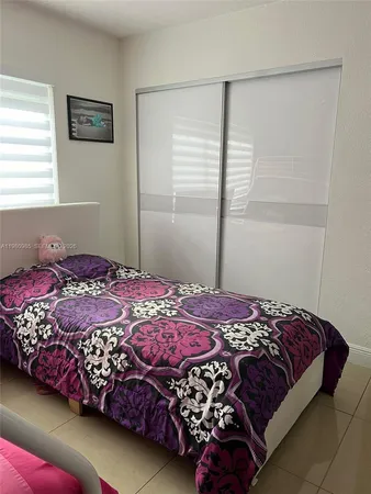 a bedroom with a bed and a sink