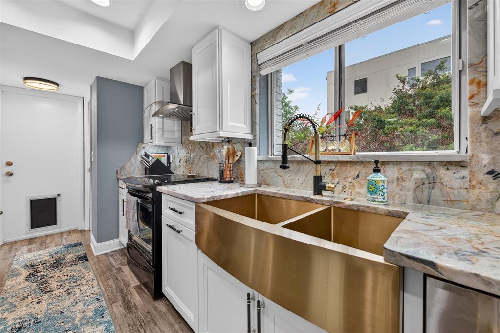 92 Alberta Avenue Ponce Inlet, FL 32127 - Photo 13 of 31 a kitchen with a sink and a refrigerator