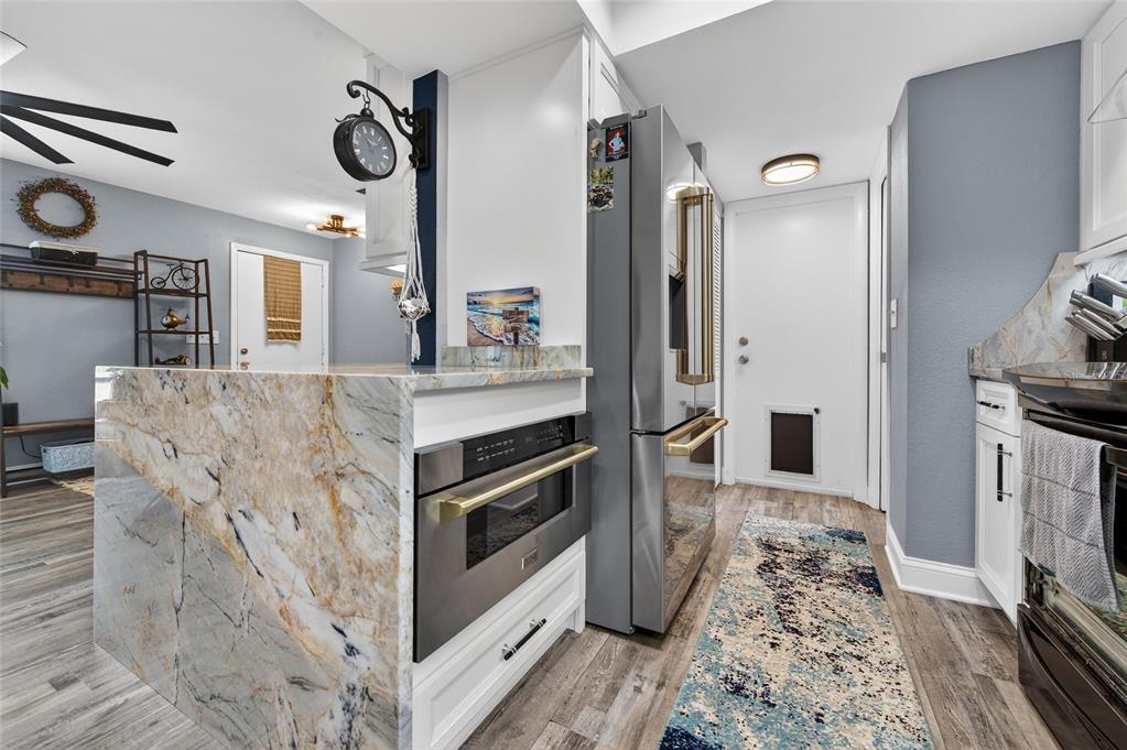 92 Alberta Avenue Ponce Inlet, FL 32127 - Photo 14 of 31 a kitchen with stainless steel appliances granite countertop a refrigerator and a stove