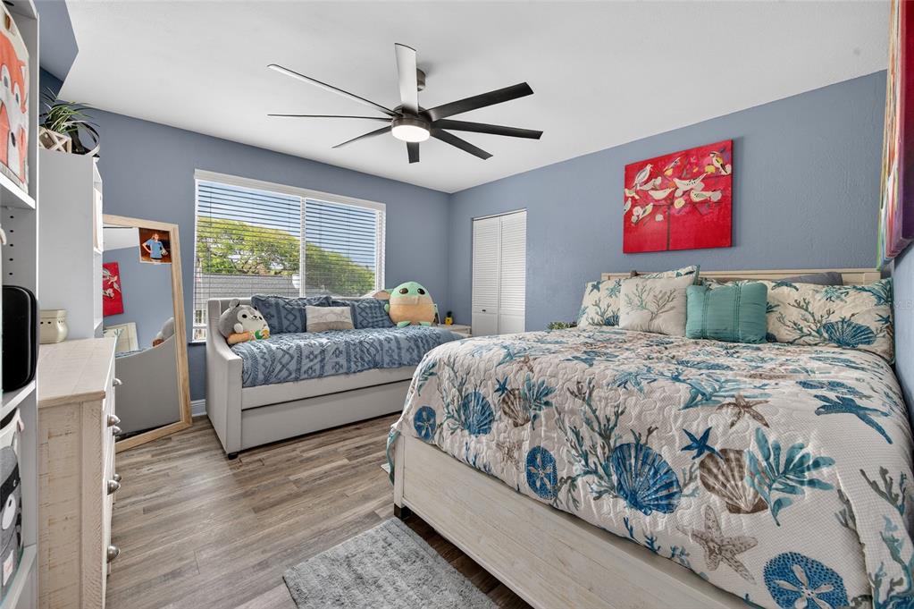 92 Alberta Avenue Ponce Inlet, FL 32127 - Photo 17 of 31 a bedroom with a large bed and a chandelier