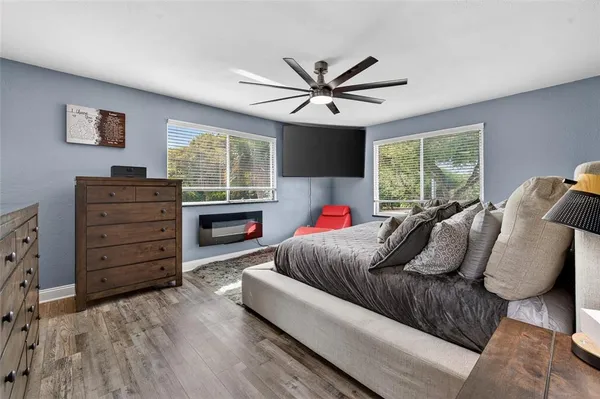a spacious bedroom with a bed and window