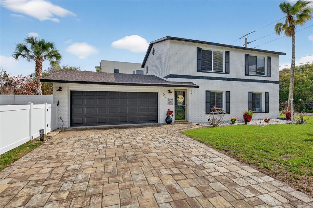 92 Alberta Avenue Ponce Inlet, FL 32127 - Photo 2 of 31 a front view of a house with a yard and garage