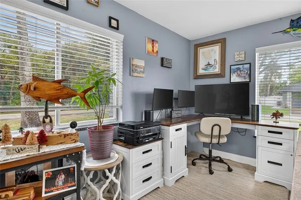 a kitchen with stainless steel appliances granite countertop a sink dishwasher a dining table and chairs with wooden floor