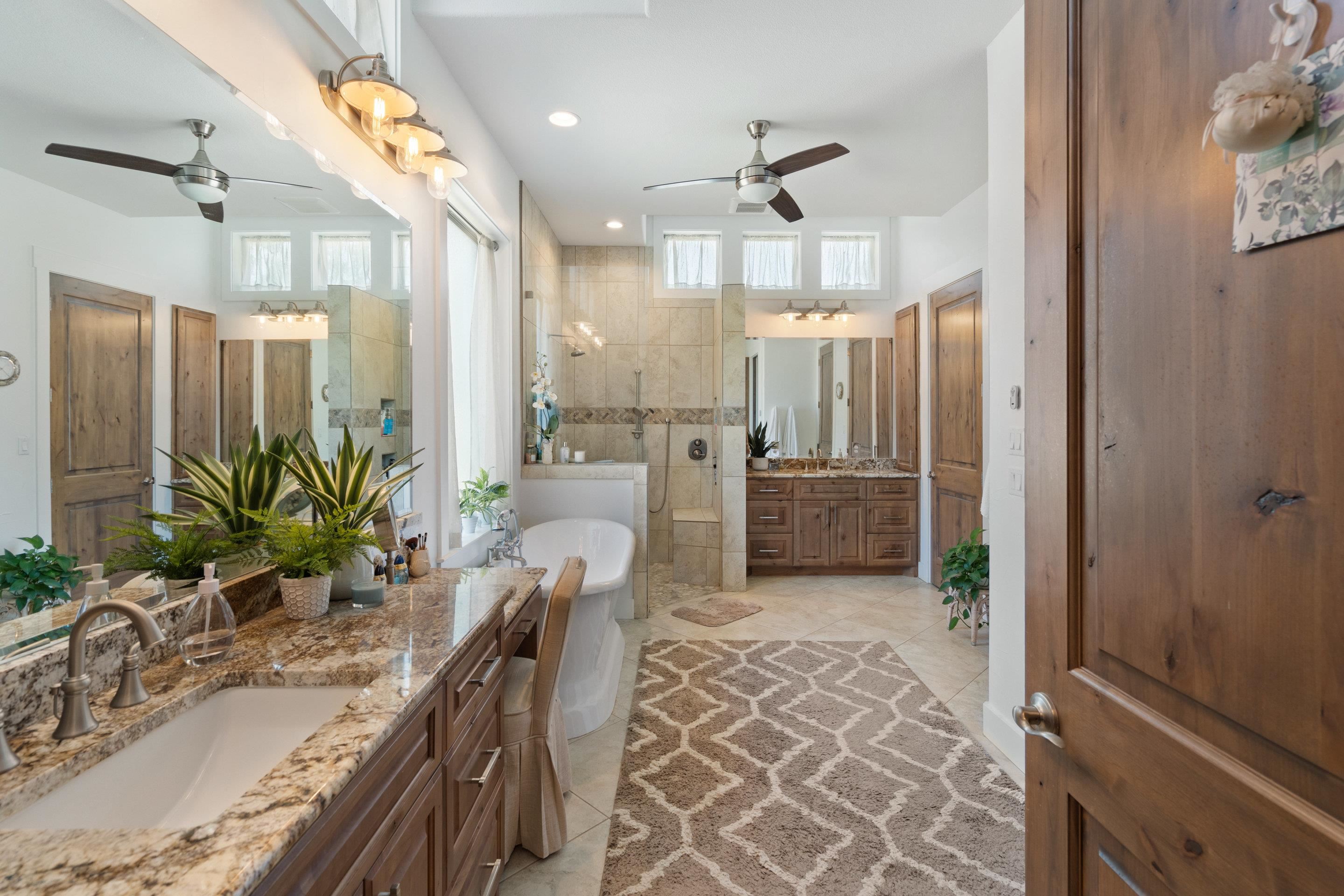 175 Scenic Ridge Drive Spicewood, TX 78669 - Photo 14 of 30 a bathroom with a granite countertop sink a mirror and shower