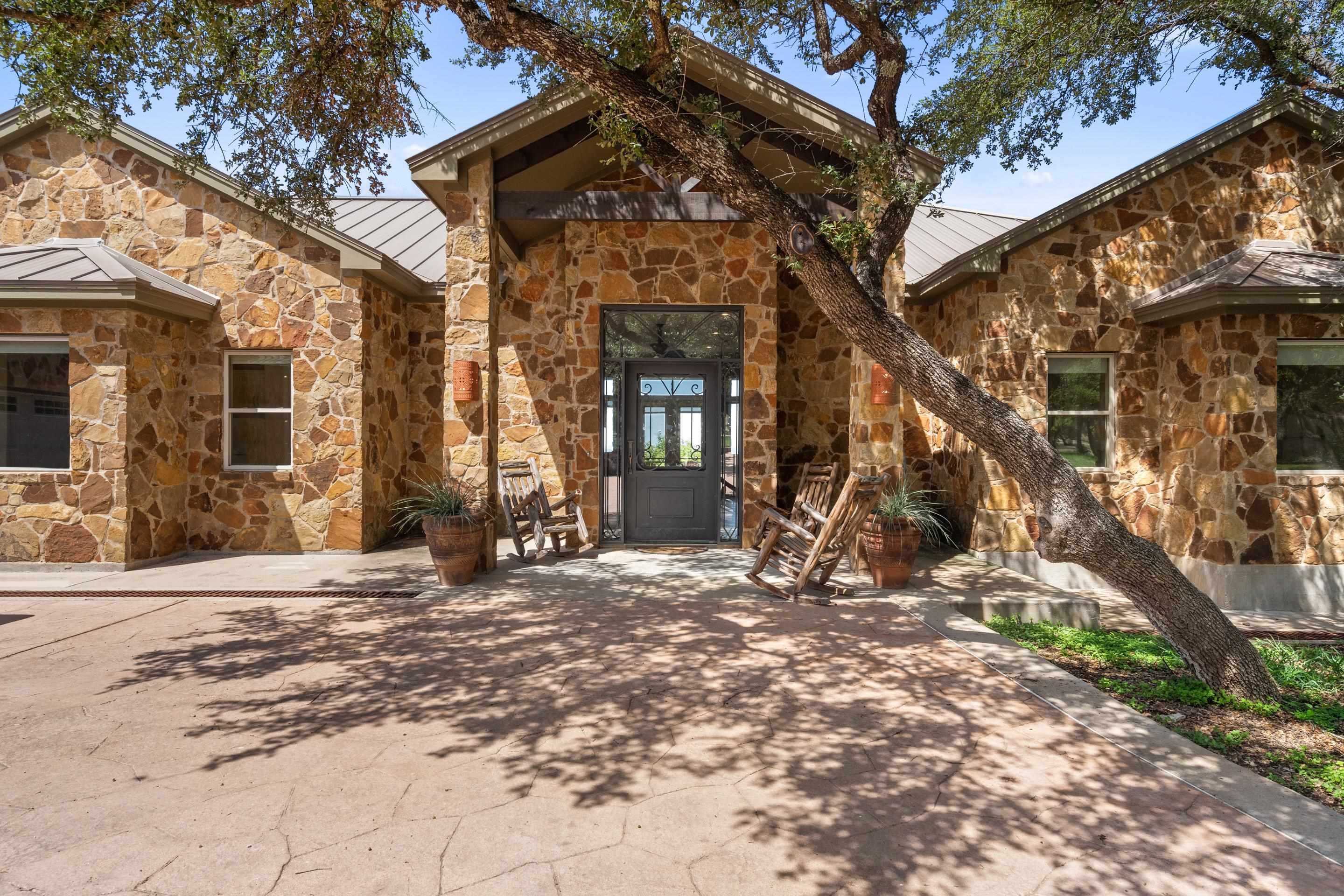 175 Scenic Ridge Drive Spicewood, TX 78669 - Photo 2 of 30 a view of a house with backyard porch and a tree