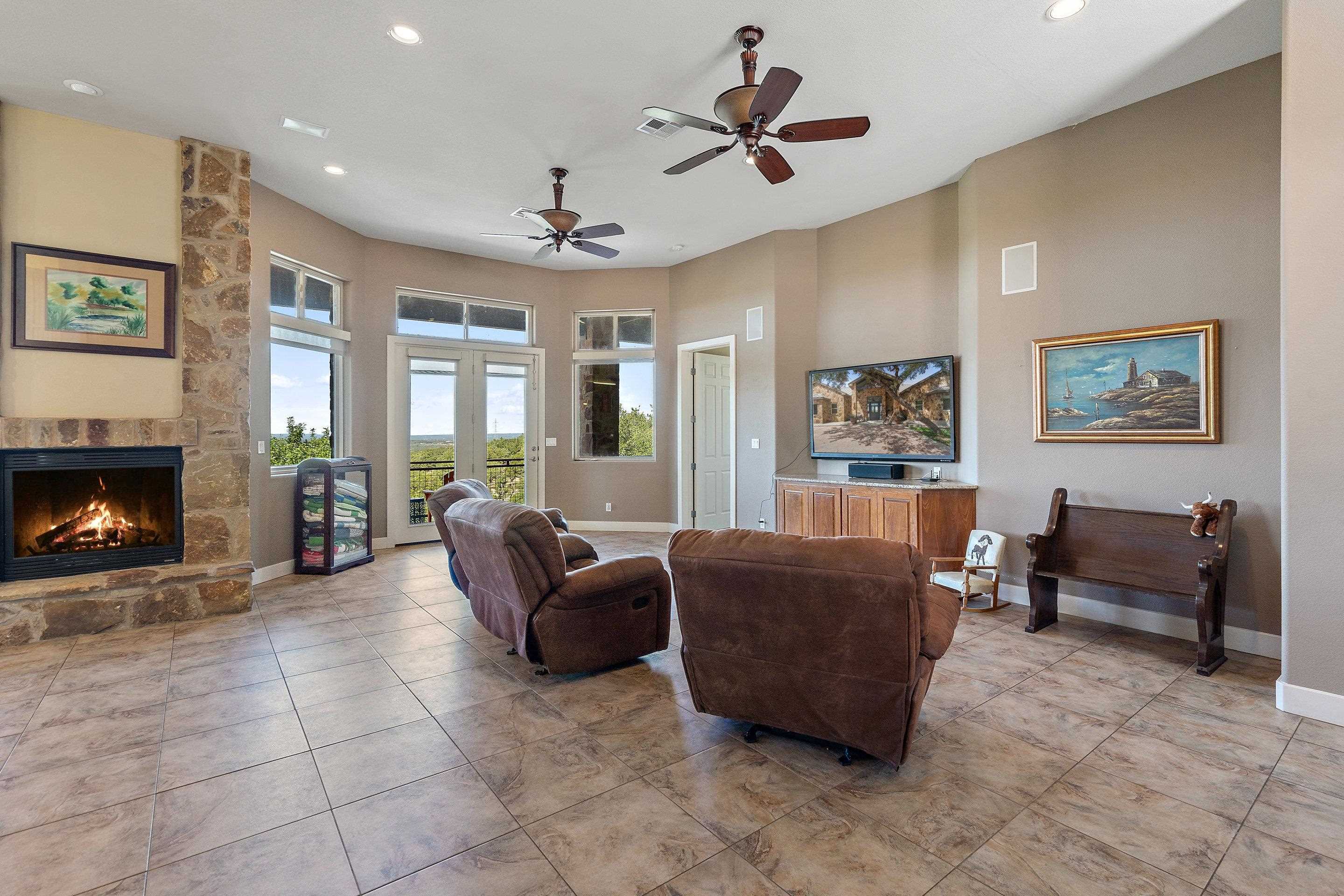 175 Scenic Ridge Drive Spicewood, TX 78669 - Photo 23 of 30 a living room with furniture and a fireplace