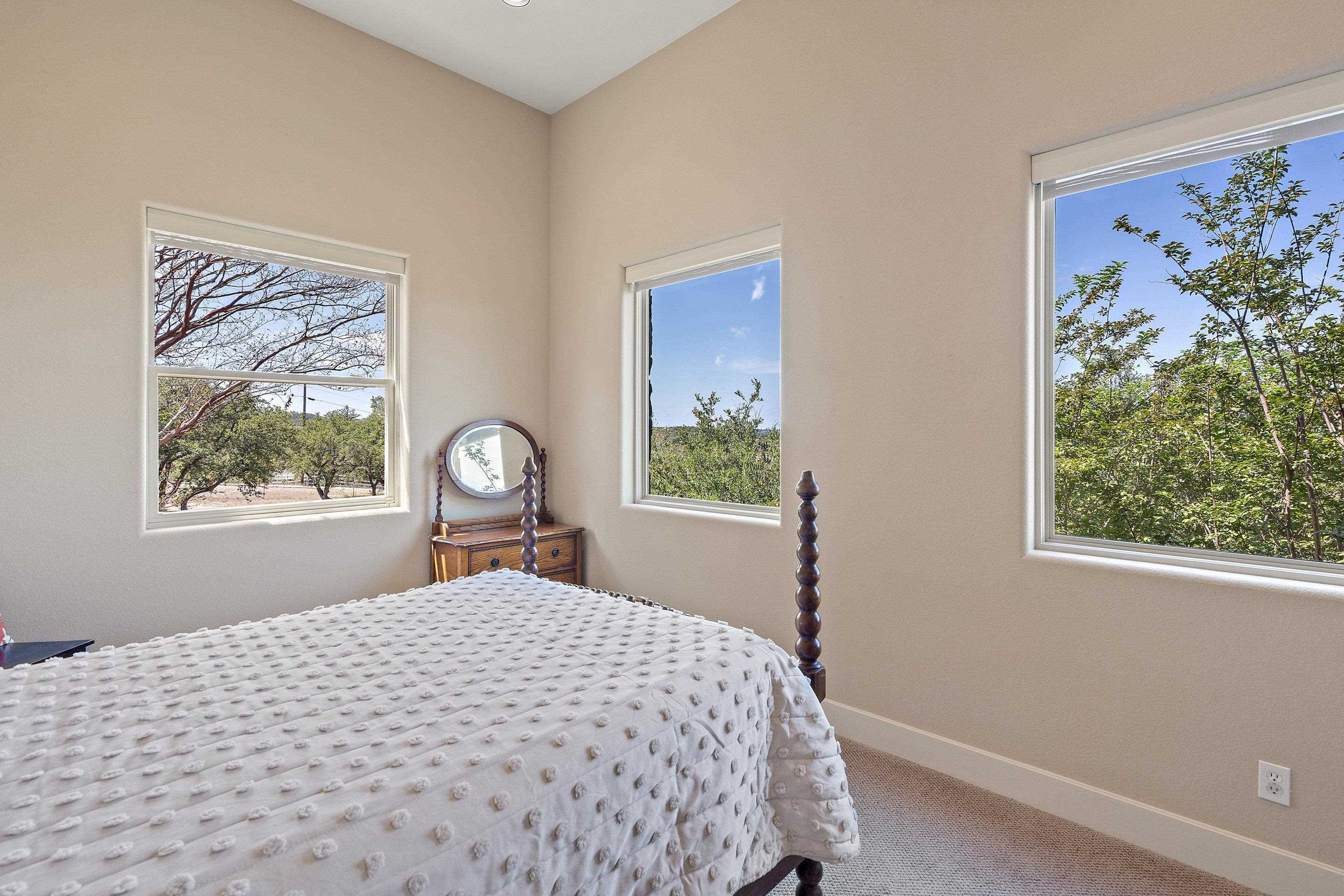 175 Scenic Ridge Drive Spicewood, TX 78669 - Photo 27 of 30 a bedroom with a bed and a window