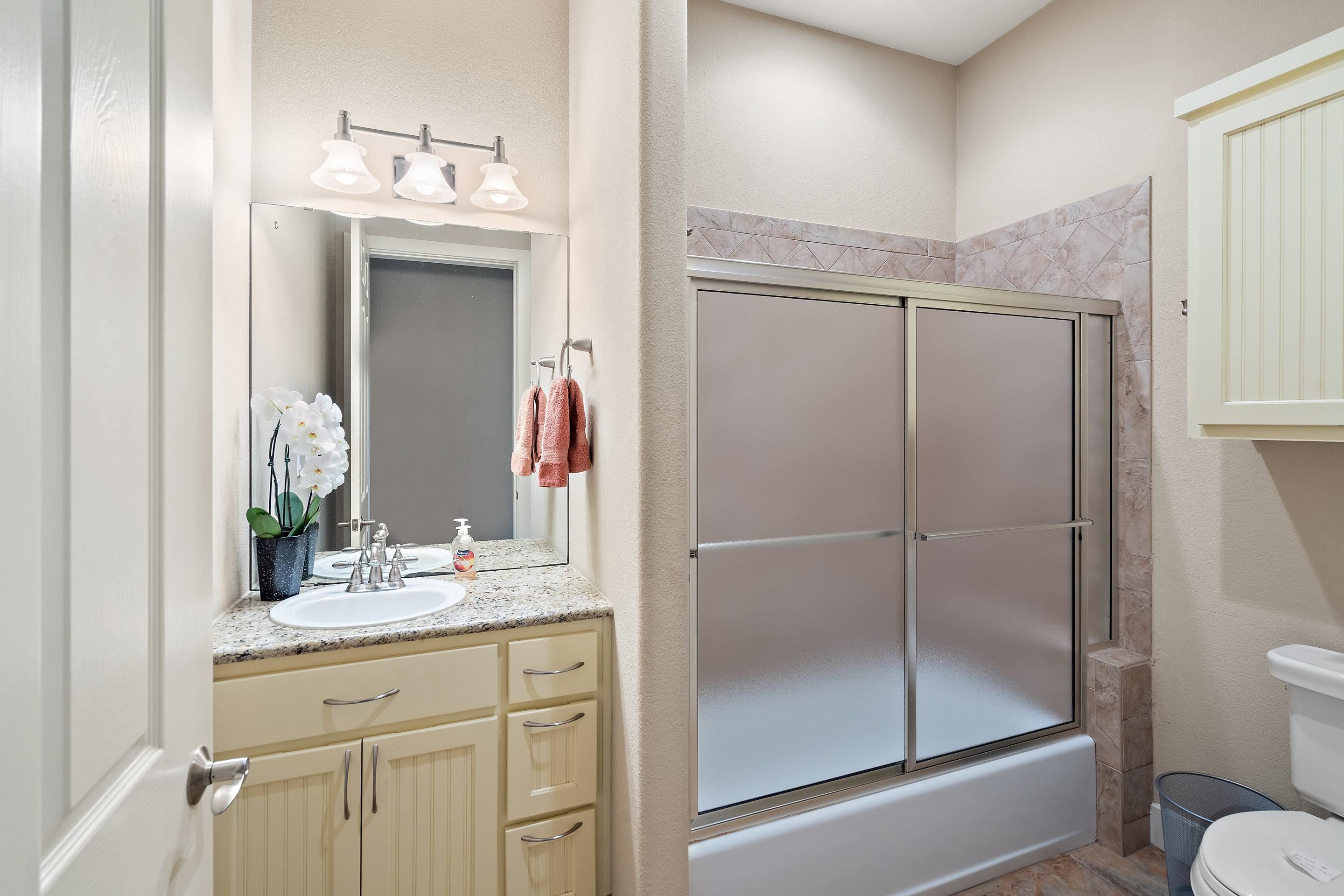 175 Scenic Ridge Drive Spicewood, TX 78669 - Photo 28 of 30 a bathroom with a granite countertop sink mirror and toilet