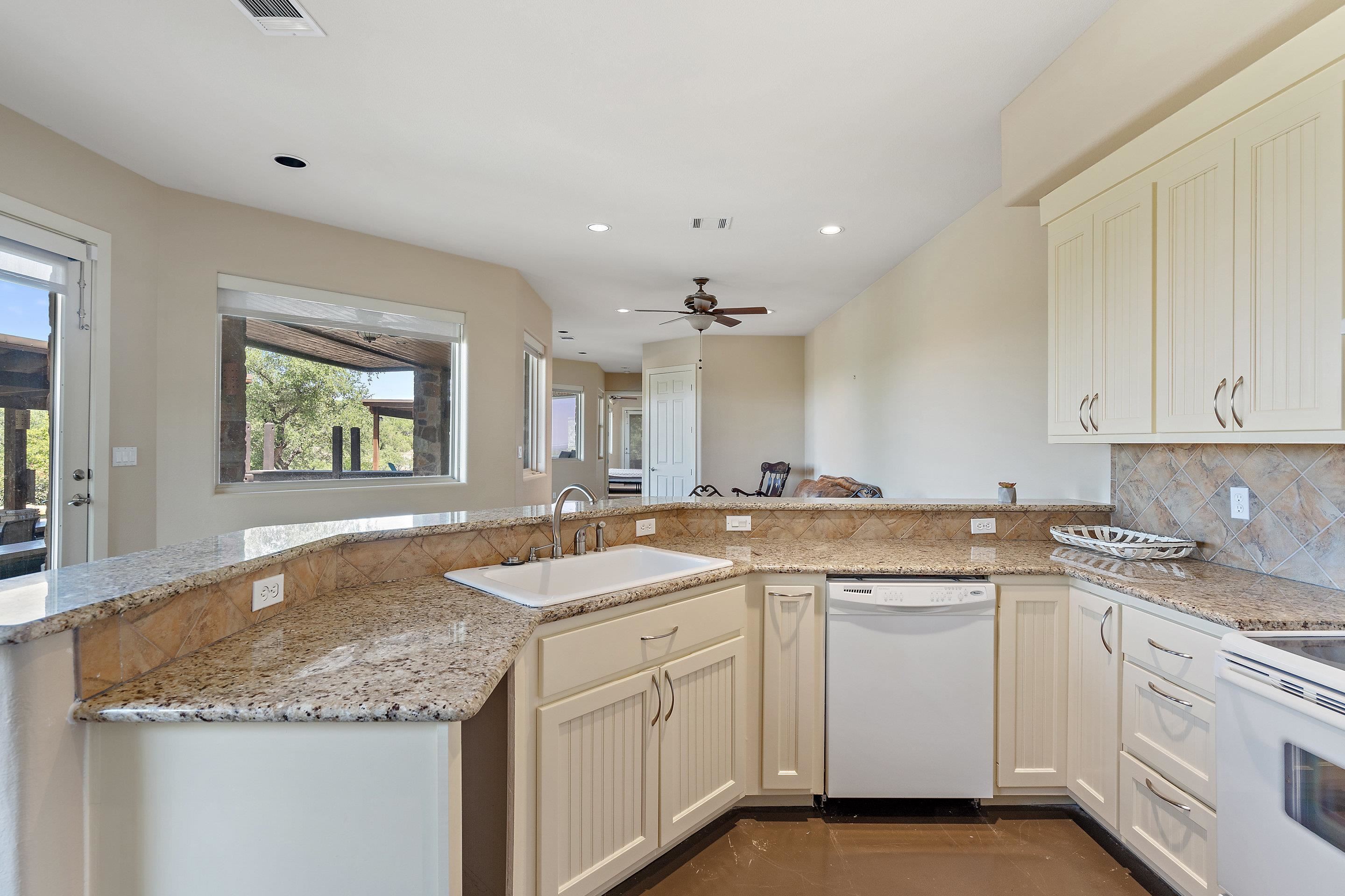 175 Scenic Ridge Drive Spicewood, TX 78669 - Photo 29 of 30 a kitchen with white cabinets appliances and a sink