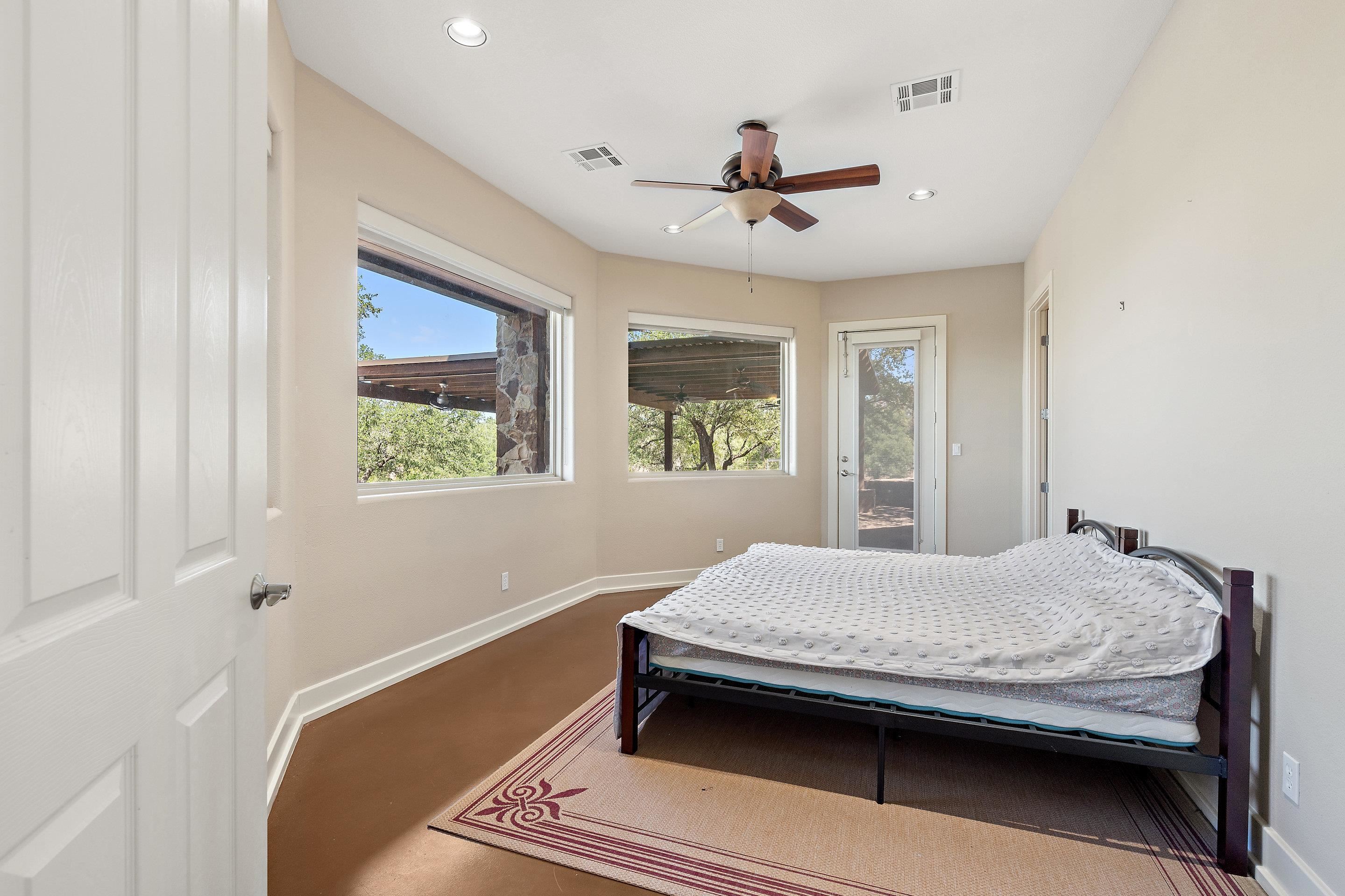 175 Scenic Ridge Drive Spicewood, TX 78669 - Photo 30 of 30 a bedroom with a bed and a window