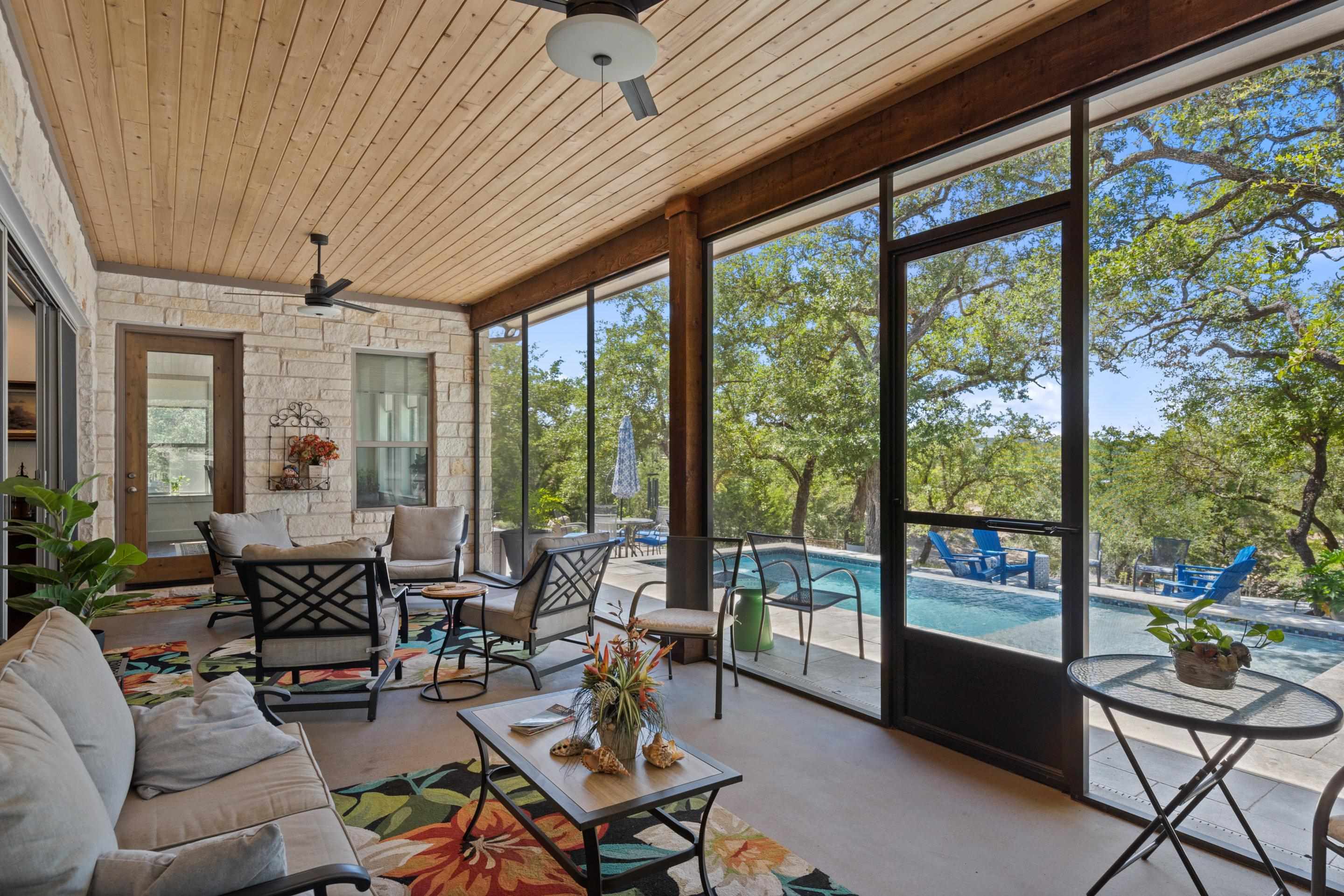 175 Scenic Ridge Drive Spicewood, TX 78669 - Photo 9 of 30 a living room with furniture and a floor to ceiling window