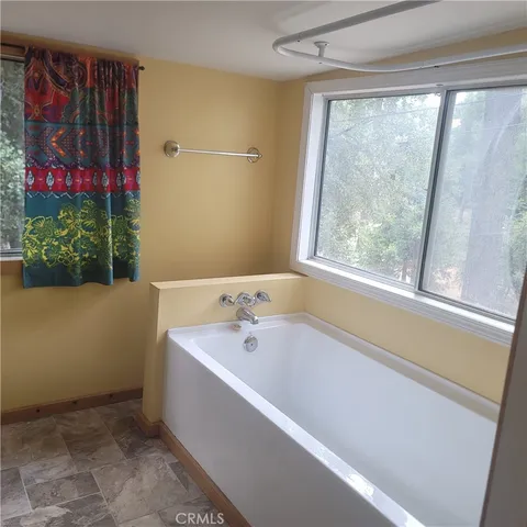 a bathroom with a toilet sink and window